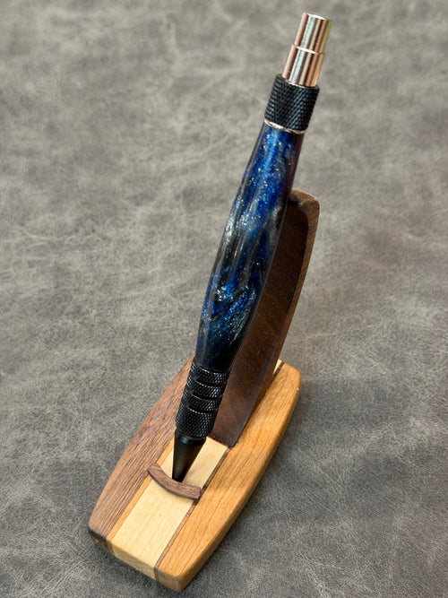 Queen City Duraclick EDC pen showing the blue, black, and silver shimmer blank from an angled view