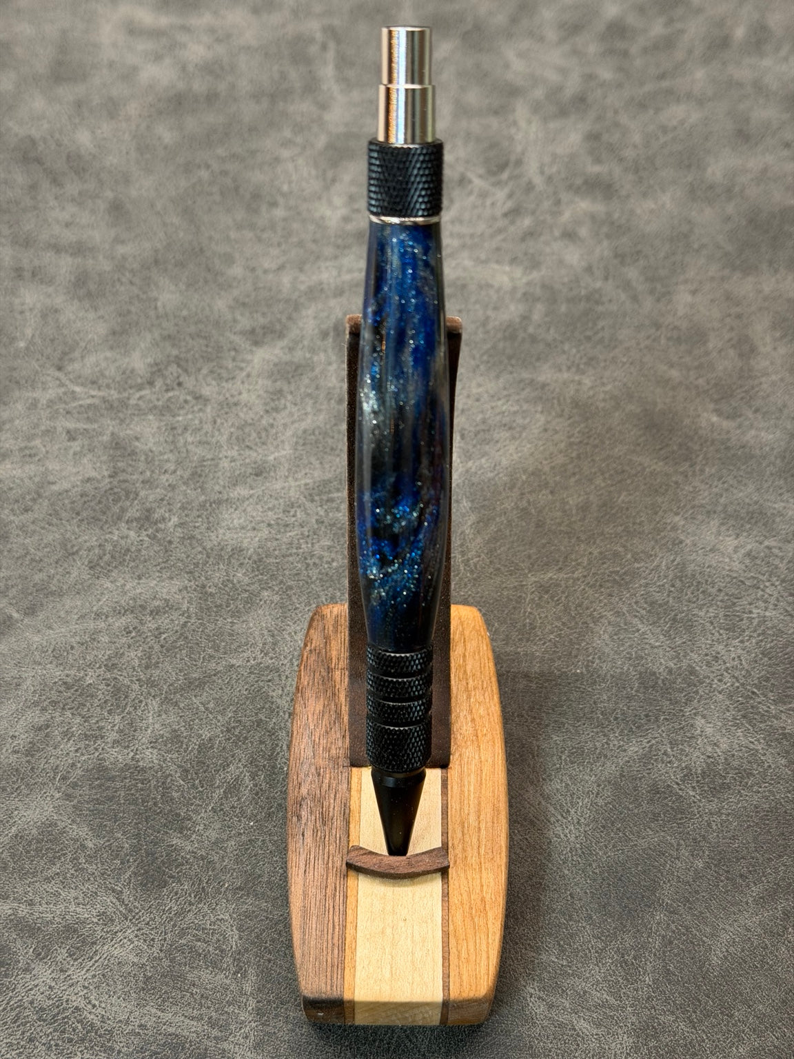 Queen City Duraclick EDC pen in black aluminum with chrome accents and a deep blue resin blank, front view