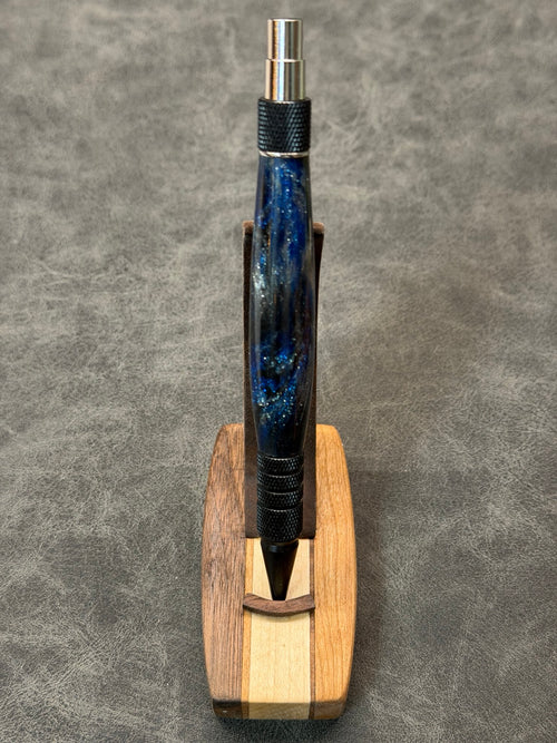 Queen City Duraclick EDC pen in black aluminum with chrome accents and a deep blue resin blank, front view